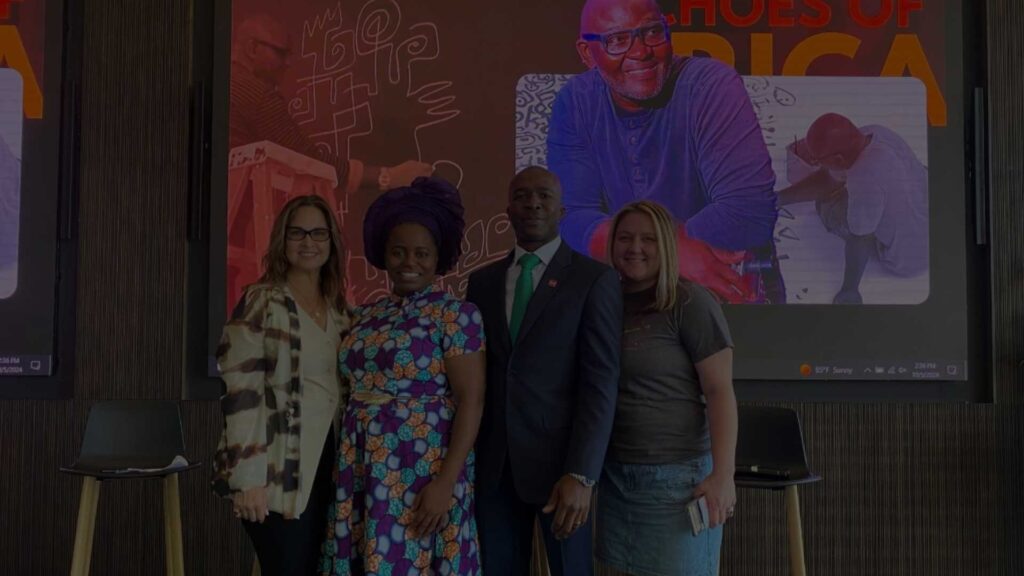 People gathered at a CADI community art and education event, celebrating African culture